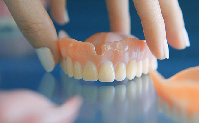 technician reviewing dentures.